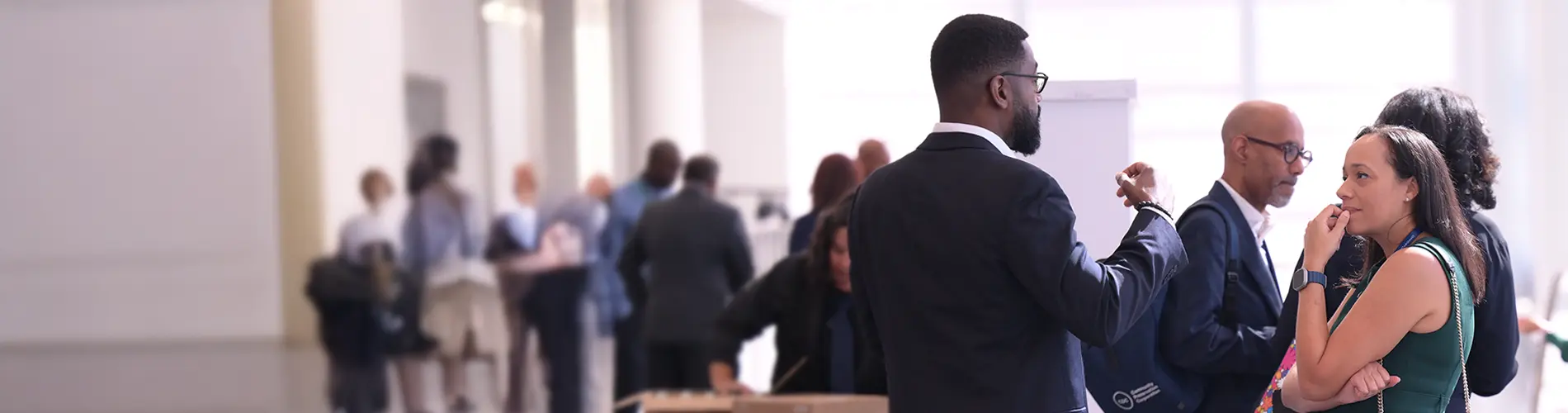 Business man and business woman conversing outside a conference hall