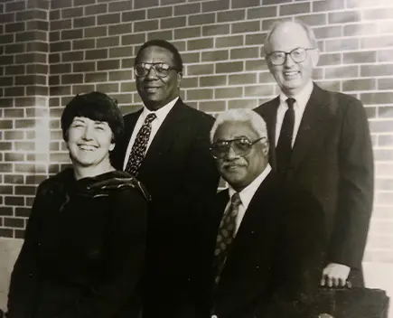 The four founders of Shorebank are seated and posed in a black and white photo.
