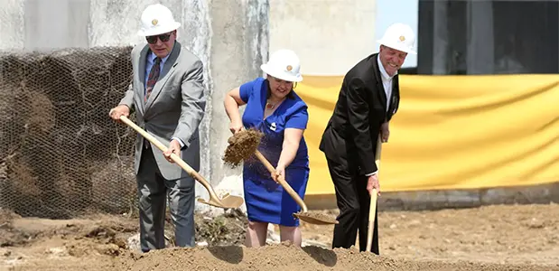 3 members of old historic carnation groundbreaking council breaking ground with 3 shovels.