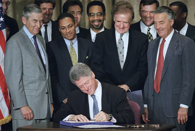 President Bill Clinton signs the The Riegle Community Development and Regulatory Improvement Act in 1994. Source: The Washington Post.