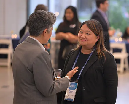 A CEO and Executive conversing at the OFN Conference