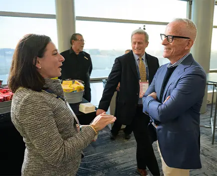 Man and woman conversing in a conference room