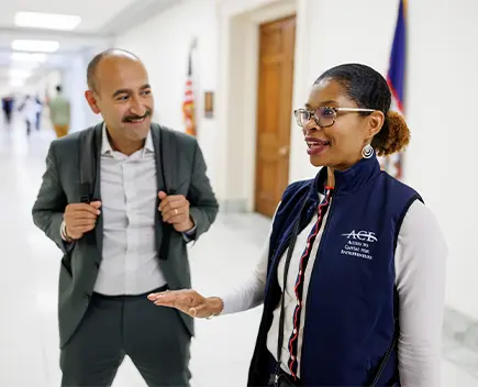 ACE representative and OFN Conference attendee smiling in conversation