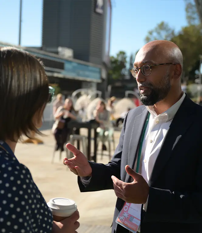 Two OFN Conference attendees conversing outside event building